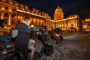 Young people riding MonsteRollers at night in the Buda Castle