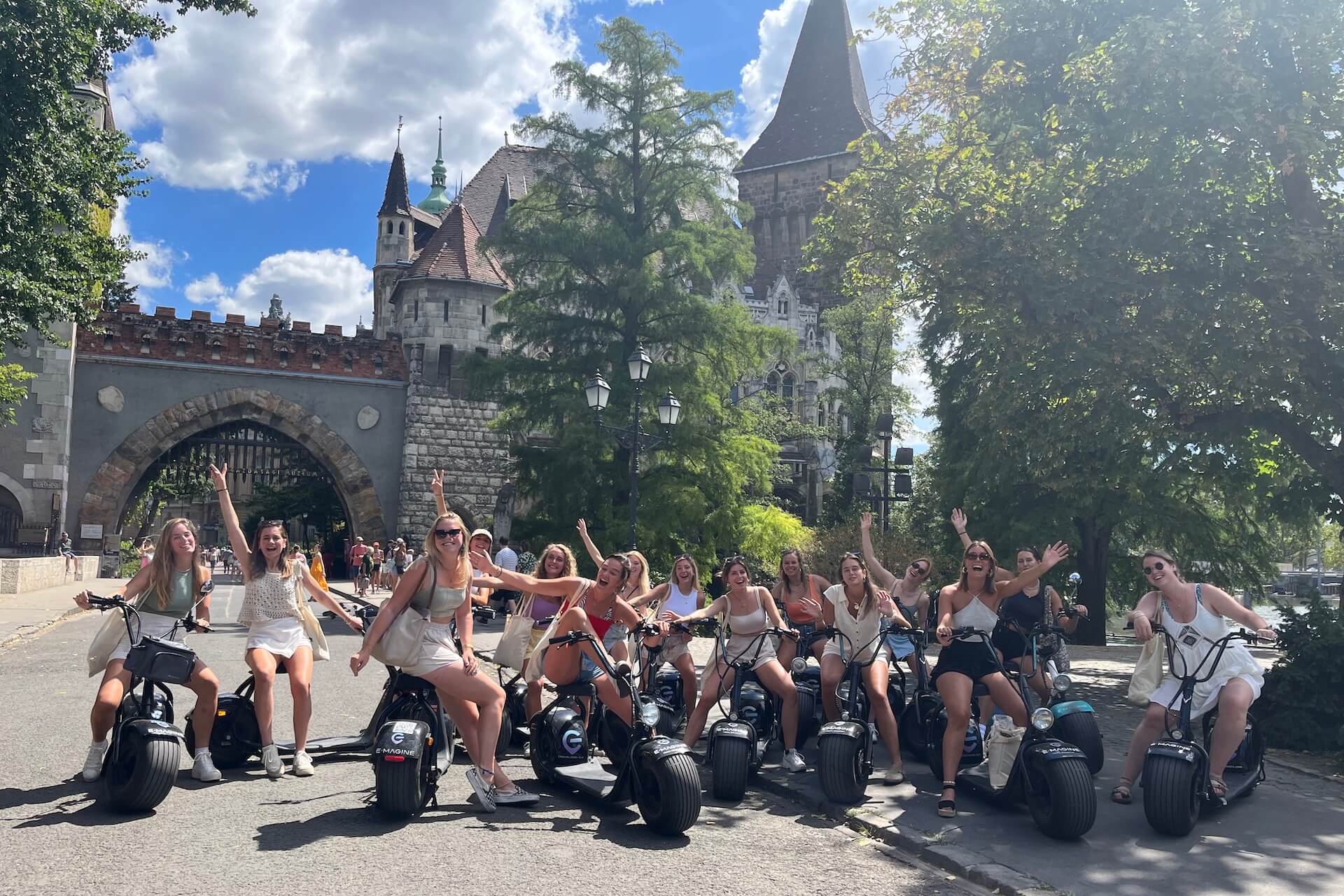 A group of young ladies on E-Scooters near Vajdahunyad Castle