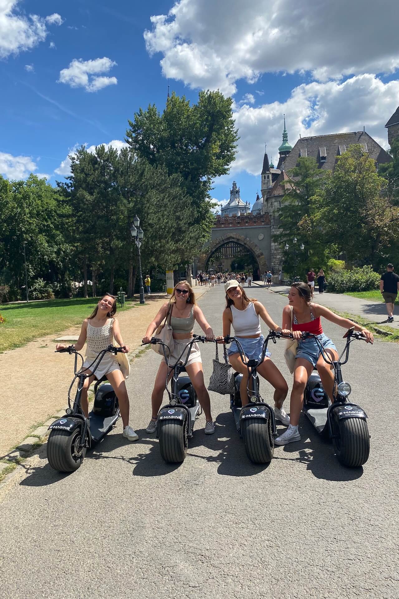 Ladies on E-Scooters in front of Vajdahunyad Castle
