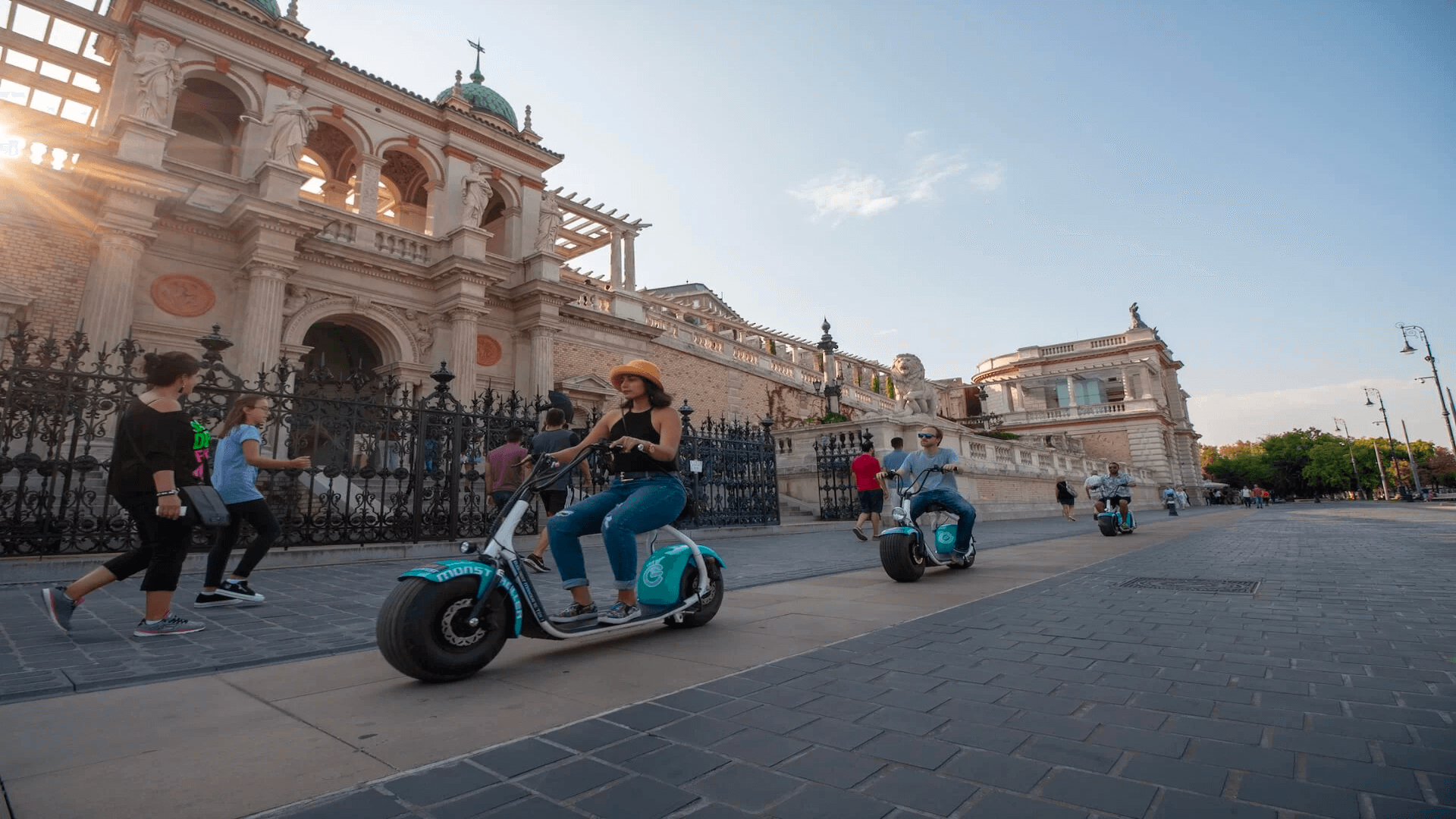 monsteroller e-scooters riding in front of the Castle Garden Bazaar