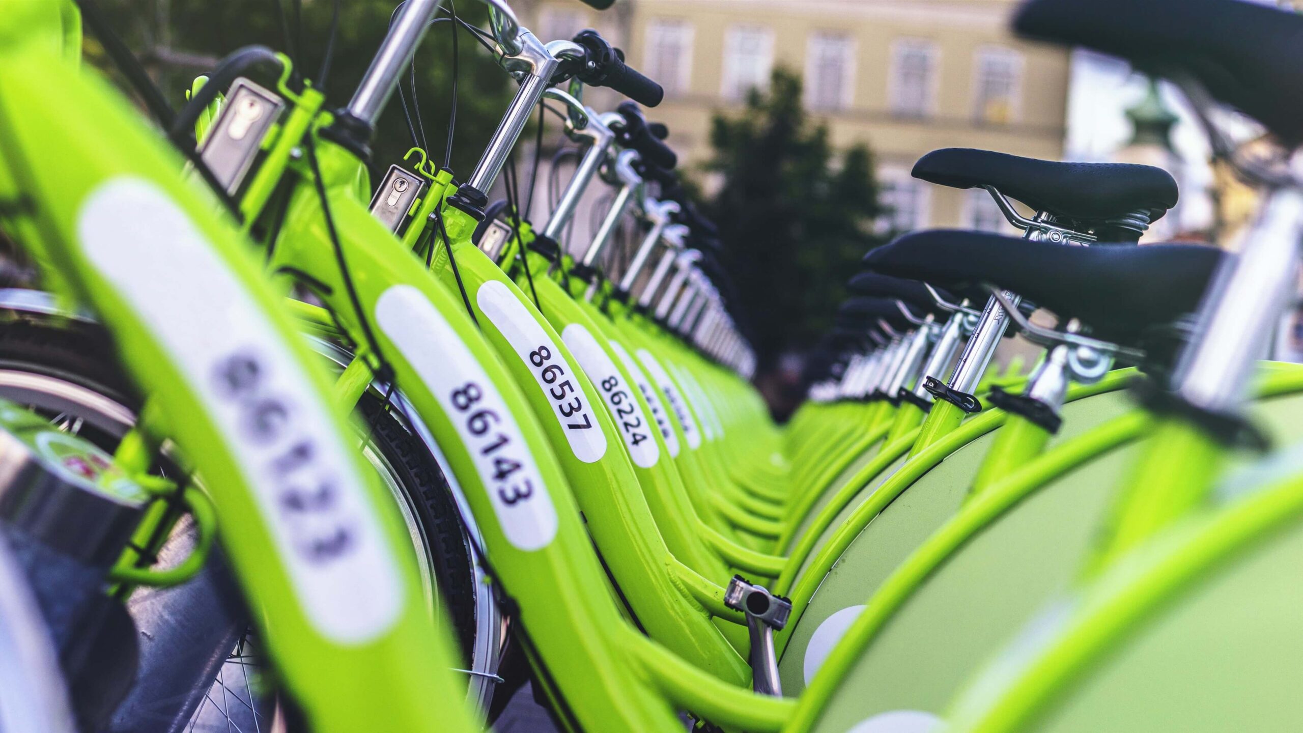 Bright green MOL BuBi bikes standing a rack in Budapest.