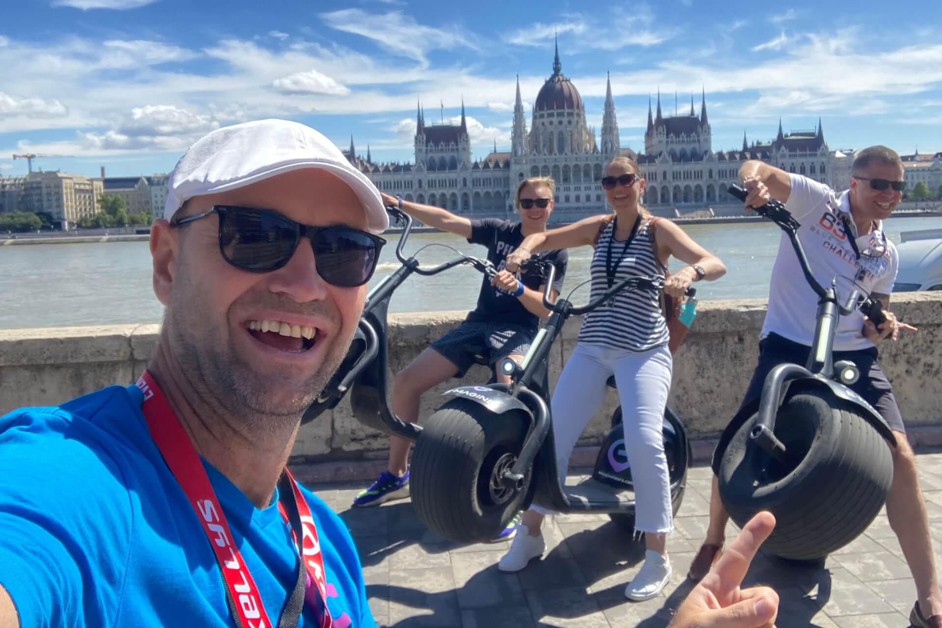 having fun on escooters with the budapest parliament across the danuber river in the background