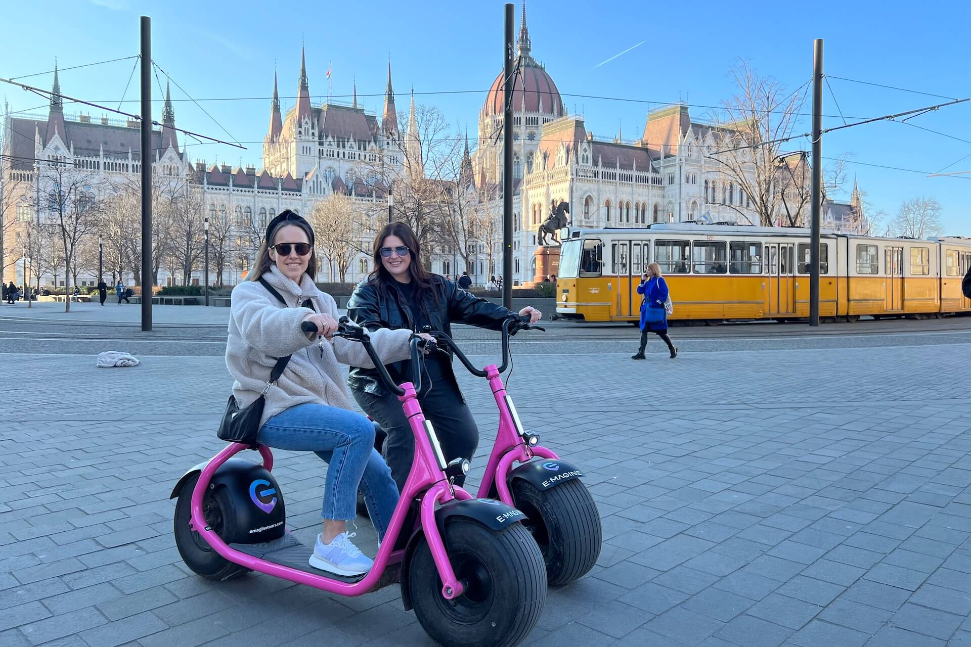 monsteroller escooters in front of the Budapest parliament building