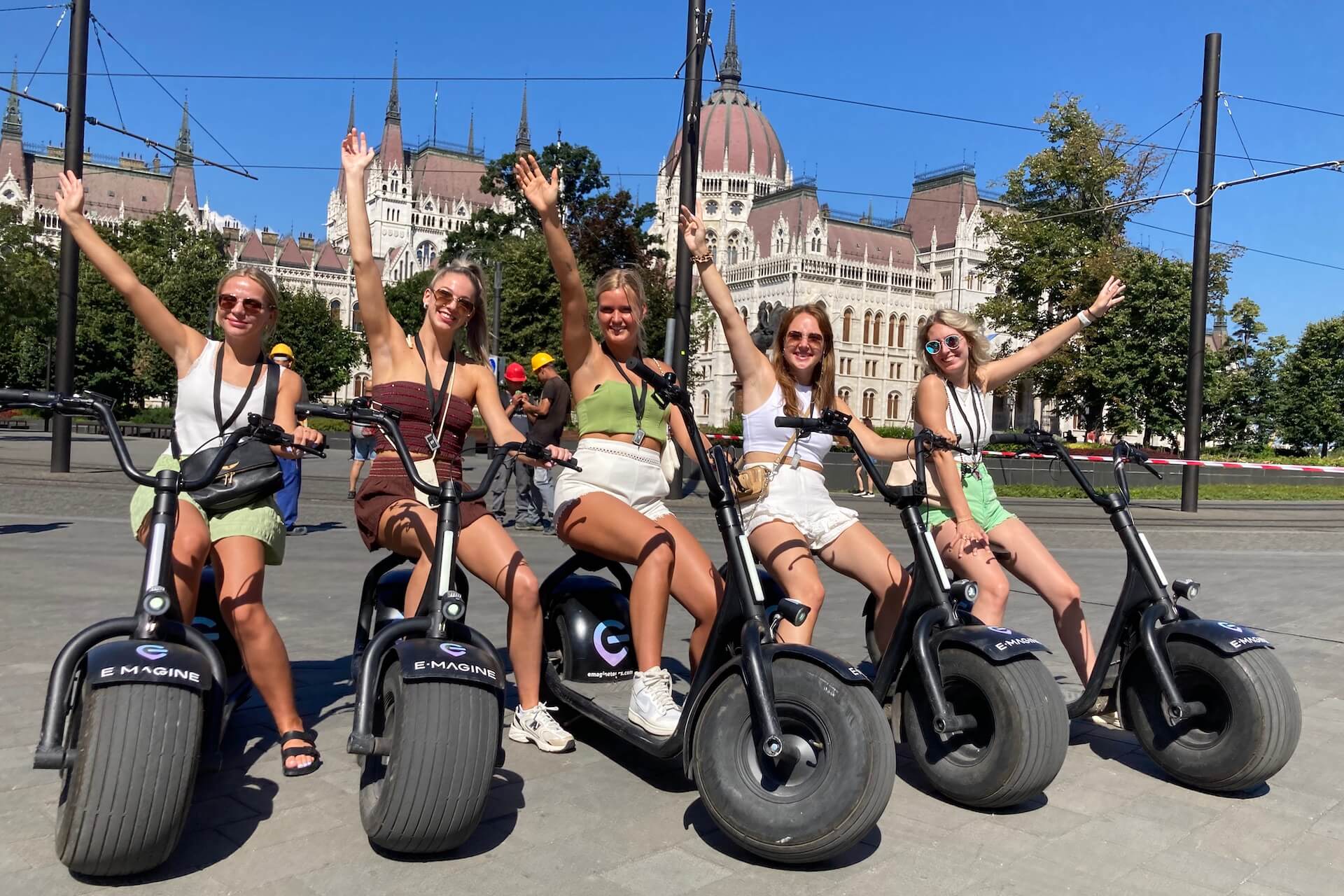 a group of girls on escooters in the summer in Budapest